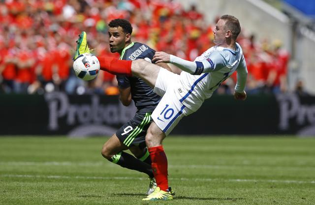 England's Wayne Rooney (right) goes for the ball with Wales' Hal Robson Kanu during the Euro 2016 Group B football match between England and Wales at the Bollaert stadium in Lens, France. (AP Photo) England's Wayne Rooney (right) goes for the ball with Wales' Hal Robson Kanu during the Euro 2016 Group B football match between England and Wales at the Bollaert stadium in Lens, France. (AP Photo)