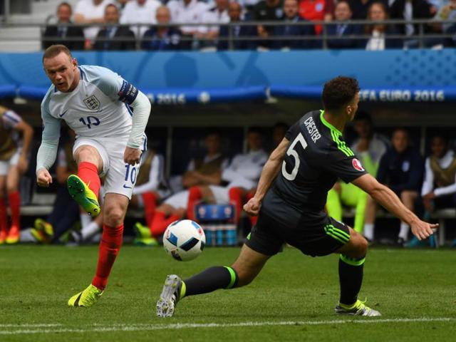 England's Wayne Rooney, left, attempts a shot at goal. (AP)