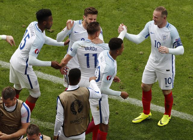 England's Jamie Vardy (centre) is congratulated by his teammate Wayne Rooney after he scored their first goal during the Euro 2016 Group B football match between England and Wales. (AP Photo) England's Jamie Vardy (centre) is congratulated by his teammate Wayne Rooney after he scored their first goal during the Euro 2016 Group B football match between England and Wales. (AP Photo)