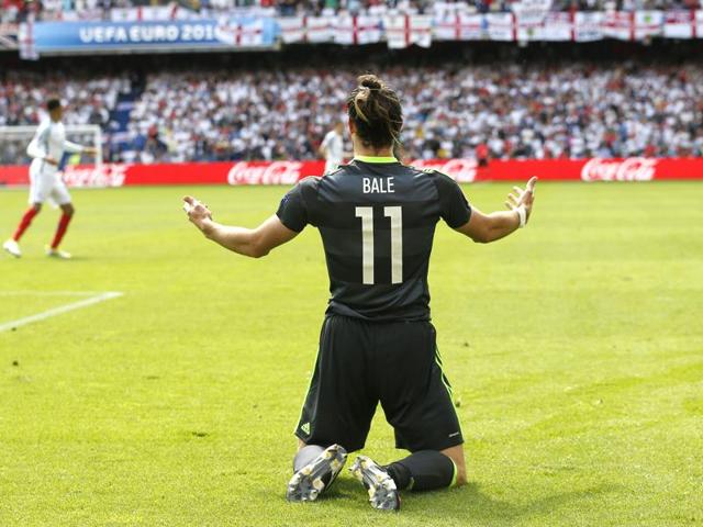 Bale opens his arms and gestures after taking a tumble. (AP)