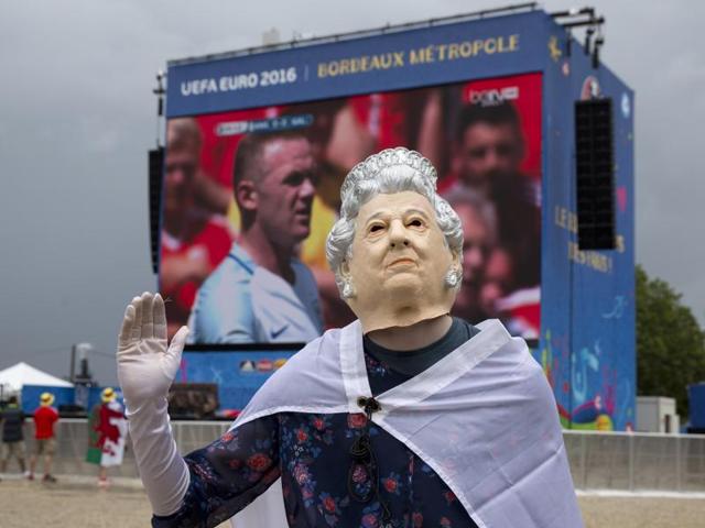 A British fan wearing a mask representing Britain's Queen Elizabeth II waves to other fans. (AP photo) A British fan wearing a mask representing Britain's Queen Elizabeth II waves to other fans. (AP photo)