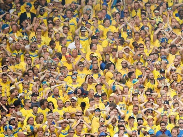 Sweden supporters put their hands to their heads after a missed chance to score in the last minutes of the Euro 2016 Group E football match between Italy and Sweden at the Stadium municipal in Toulouse, France. (AP Photo)