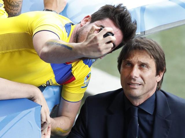 Italy coach Antonio Conte poses for a photo with a spectator after the Euro 2016 Group E football match between Italy and Sweden at the Stadium municipal in Toulouse. (AP Photo)