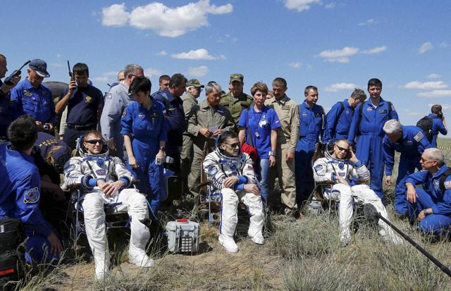 The ISS crew, from left, Britain's Tim Peake, Russia's Yuri Malenchenko and Tim Kopra of US, surrounded by ground personnel.  (AP Photo)
