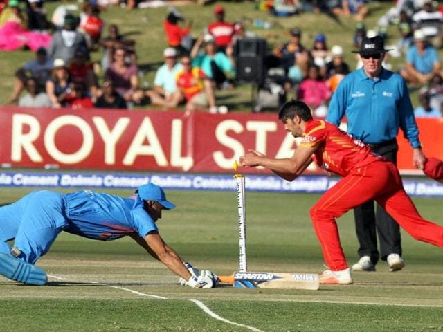 MS Dhoni, left, dives to avoid a run out. (AP) MS Dhoni, left, dives to avoid a run out. (AP)