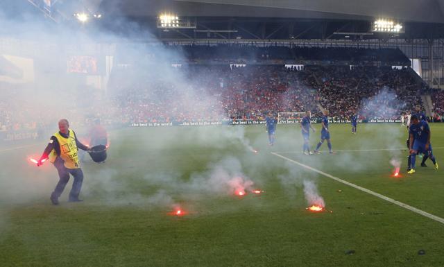 Flares are thrown onto the pitch during the Euro 2016 Group D match. (AP Photo) Flares are thrown onto the pitch during the Euro 2016 Group D match. (AP Photo)