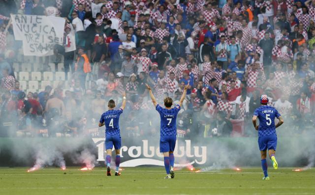 Croatia players gesture towards the fans who appeared to have thrown flares on to the pitch. (REUTERS)