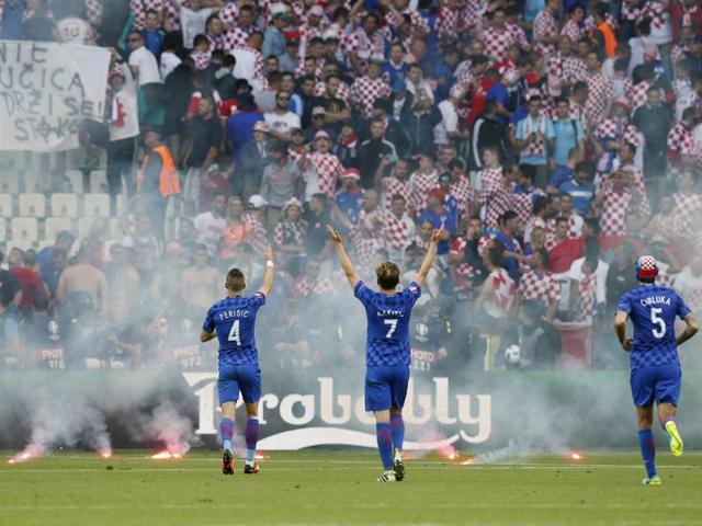 Croatia players gesture towards fans who appeared to have thrown the flares. (REUTERS)