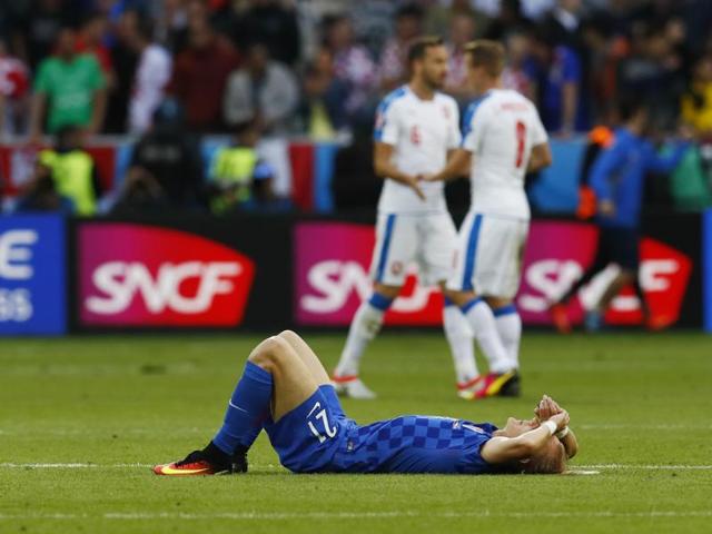 Croatia's Domagoj Vida looks dejected as Czech Republic players celebrate at the end of the match. (REUTERS)