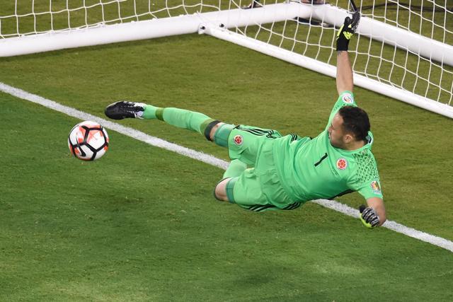 Colombia's goalkeeper David Ospina stops a penalty shot by Peru's Miguel Trauco. (AFP Photo)