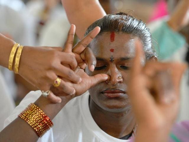 A  yoga teacher helps a student with breathing exercises during a class for transgender yoga participants in Bangalore. (AFP) 