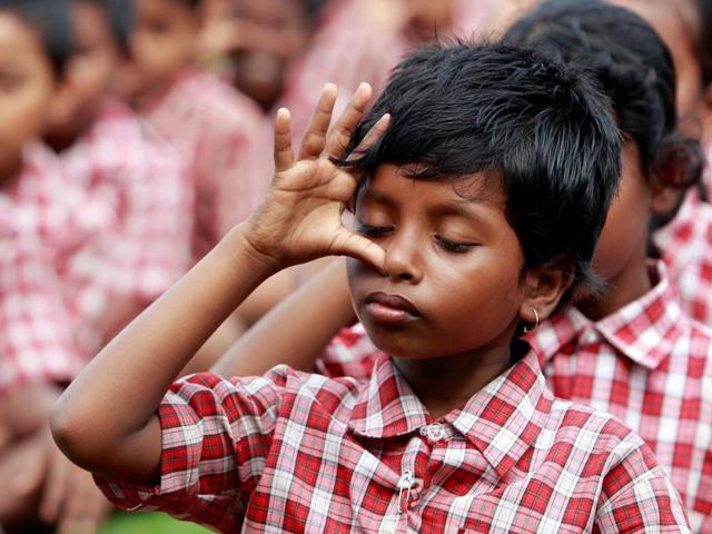 School students practice yoga during a training session ahead of World Yoga Day in Agartala. (REUTERS) 
