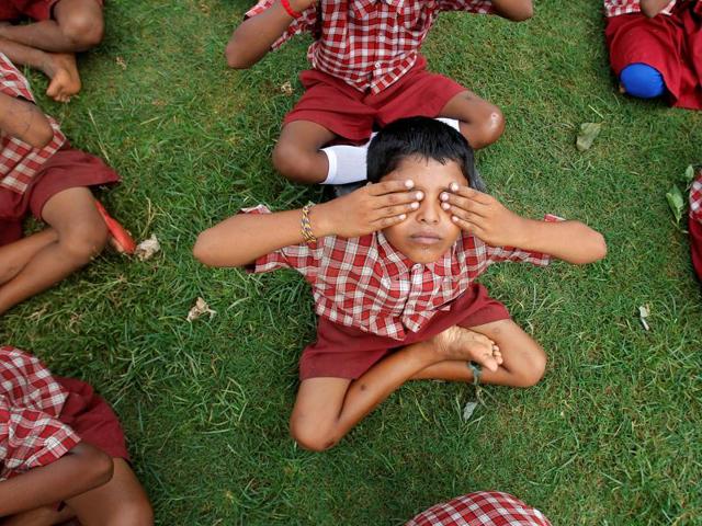 School students practice yoga during a training session ahead of World Yoga Day in Agartala. (REUTERS) 