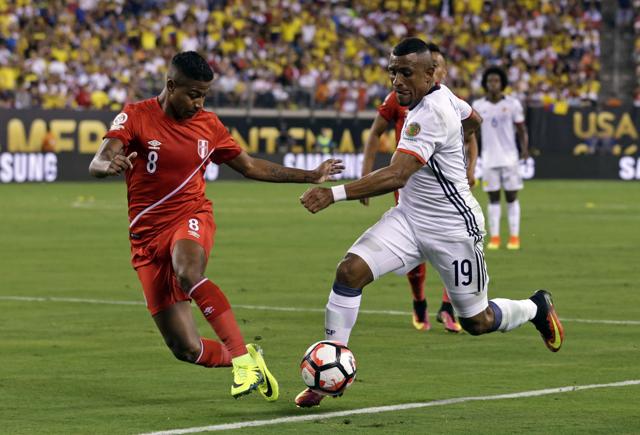 Colombia defender Farid Diaz (19) keeps the ball from Peru forward Andy Polo (8) in first half action. (USA Today Sports)