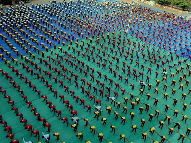 Students perform yoga ahead of International Yoga day in Surat.  (PTI) 