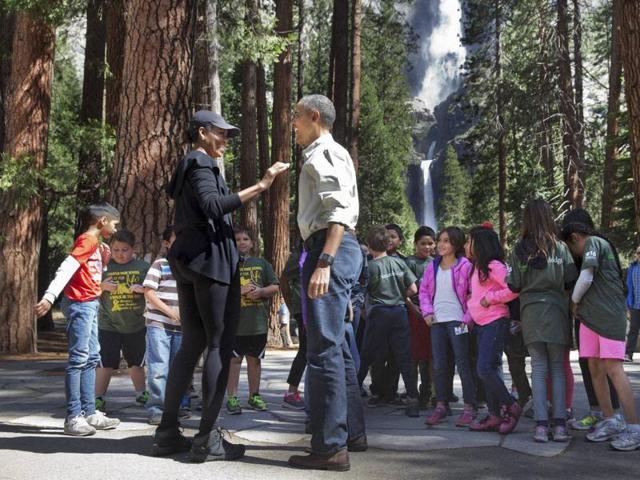 The couple meet with children at Yosemite National Park, California. It was a picture-perfect moment designed to resonate on social media. (AP) The couple meet with children at Yosemite National Park, California. It was a picture-perfect moment designed to resonate on social media. (AP)
