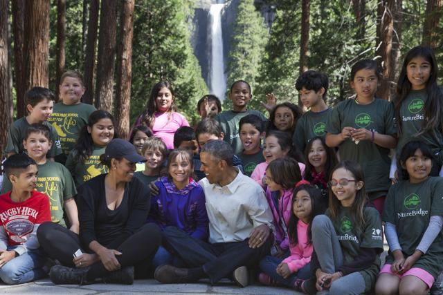 President Barack Obama and first lady Michelle Obama take a photograph with children attending an "Every Kid in a Park" event at Yosemite National Park. (AP Photo)
