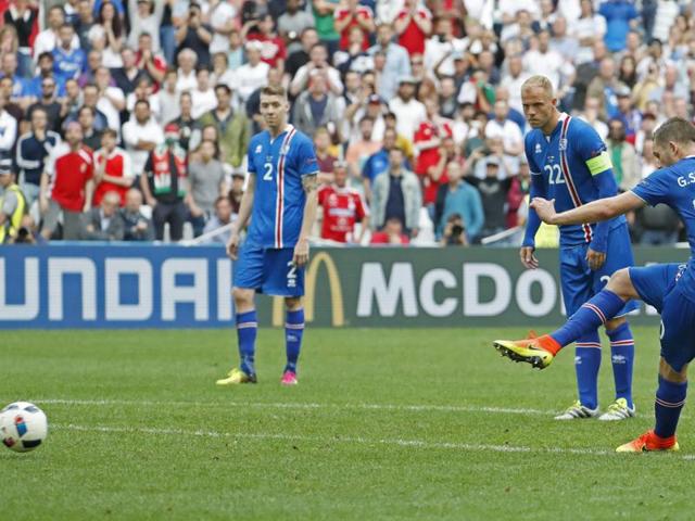 Gylfi Sigurdsson, right, takes a freekick. (REUTERS)