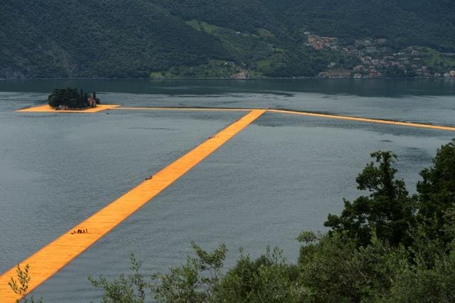 A picture shows a partial view of the monumental installation "The Floating Piers" created by artist Christo Vladimirov Javacheff and Jeanne-Claude, on June 16, 2016 during a press preview at the lake Iseo, northern Italy. (AFP) A picture shows a partial view of the monumental installation "The Floating Piers" created by artist Christo Vladimirov Javacheff and Jeanne-Claude, on June 16, 2016 during a press preview at the lake Iseo, northern Italy. (AFP)