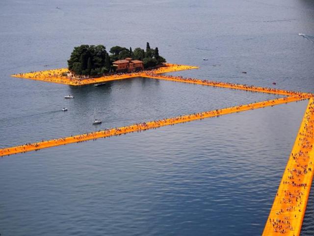 People walk on the monumental installation entitled 'The Floating Piers' created by artist Christo Vladimirov Javacheff on Iseo Lake, in northern Italy, on June 18, 2016. (AFP) People walk on the monumental installation entitled 'The Floating Piers' created by artist Christo Vladimirov Javacheff on Iseo Lake, in northern Italy, on June 18, 2016. (AFP)