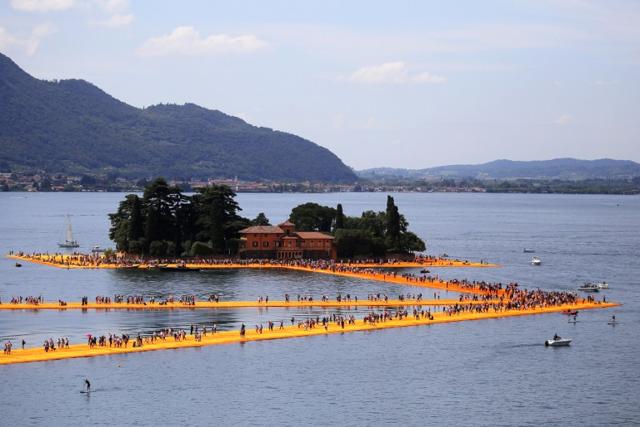 People walk on the monumental installation entitled 'The Floating Piers' created by artist Christo Vladimirov Javacheff on Iseo Lake, in northern Italy, on June 18, 2016. (AFP) People walk on the monumental installation entitled 'The Floating Piers' created by artist Christo Vladimirov Javacheff on Iseo Lake, in northern Italy, on June 18, 2016. (AFP)