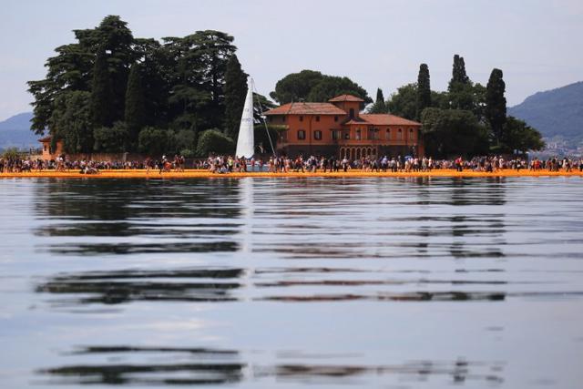 People walk on the monumental installation entitled 'The Floating Piers' created by artist Christo Vladimirov Javacheff on Iseo Lake, in northern Italy, on June 18, 2016. (AFP) People walk on the monumental installation entitled 'The Floating Piers' created by artist Christo Vladimirov Javacheff on Iseo Lake, in northern Italy, on June 18, 2016. (AFP)