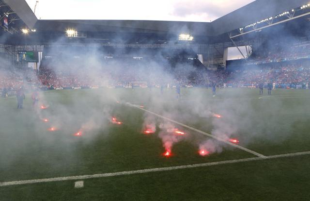 Flares are thrown onto the pitch during the Euro 2016 Group D soccer match between the Czech Republic and Croatia at the Geoffroy Guichard stadium. (AP Photo) Flares are thrown onto the pitch during the Euro 2016 Group D soccer match between the Czech Republic and Croatia at the Geoffroy Guichard stadium. (AP Photo)