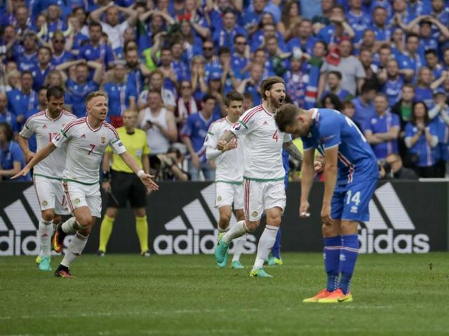 Hungarian players celebrate as an Iceland player looks disappointed at the end of the match. (AP)
