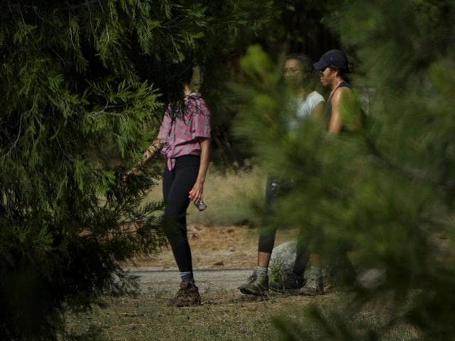 Malia Obama (L), Sasha Obama (C) and US first lady Michelle Obama are seen as they hike. (AFP) Malia Obama (L), Sasha Obama (C) and US first lady Michelle Obama are seen as they hike. (AFP)