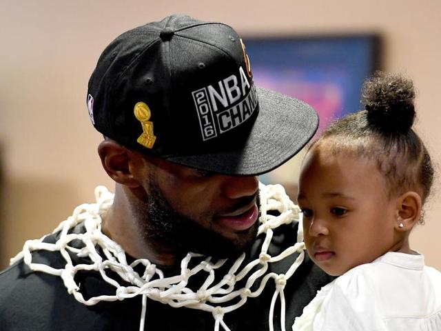 LeBron James holds his daughter Zhuri during a press conference after the game. (AFP) LeBron James holds his daughter Zhuri during a press conference after the game. (AFP)