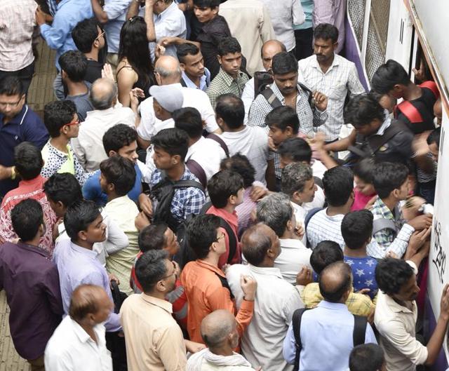 Commuters struggle to board a train at Bandra station. (vijayanand gupta) Commuters struggle to board a train at Bandra station. (vijayanand gupta)