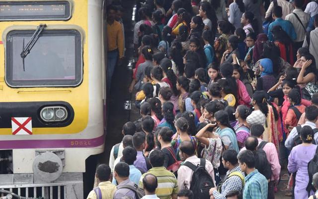 Commuters jostle to take a train at Borivli railway station. (pratham gokhale) 