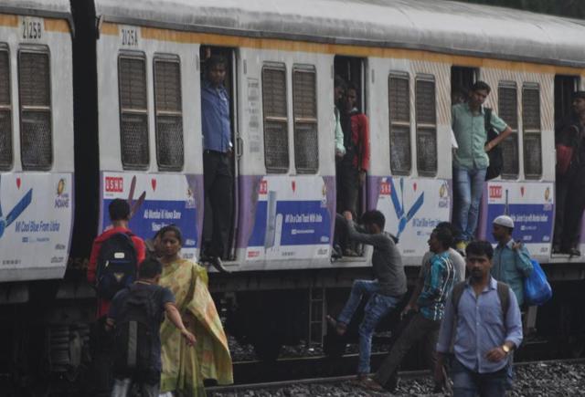 Commuters are forced to walk on the tracks after train services were halted, near Lower Parel station. (bhushan koyande) Commuters are forced to walk on the tracks after train services were halted, near Lower Parel station. (bhushan koyande)