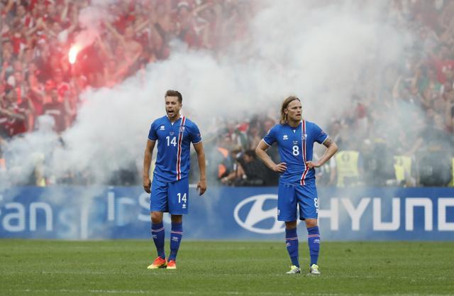 Hungary supporters threw flares on the pitch after an Iceland own goal allowed them to draw 1-1 against Iceland. (REUTERS) Hungary supporters threw flares on the pitch after an Iceland own goal allowed them to draw 1-1 against Iceland. (REUTERS)