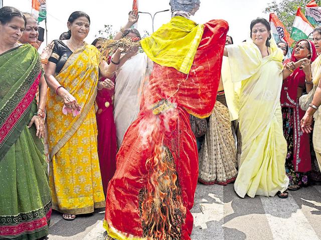State Congress women’s wing members burn an effigy of chief minister Vasundhara Raje to protest the rape of a three-year-old girl, in Jaipur on Monday. (Prabhakar Sharma/HT Photo) State Congress women’s wing members burn an effigy of chief minister Vasundhara Raje to protest the rape of a three-year-old girl, in Jaipur on Monday. (Prabhakar Sharma/HT Photo)