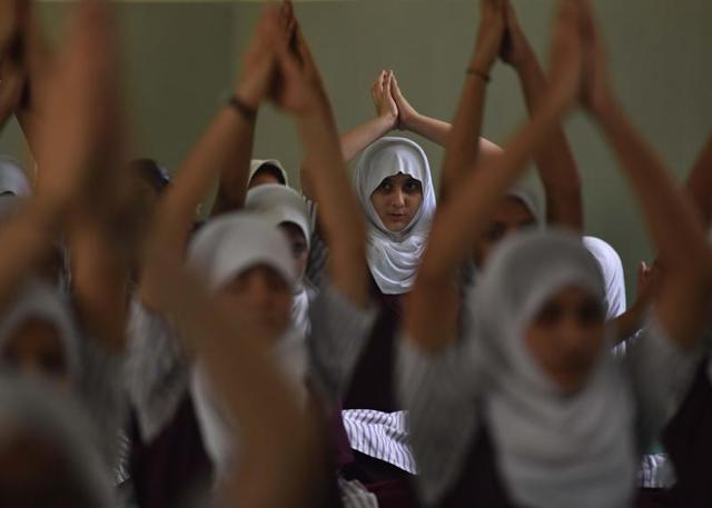 Students of NH School perform yoga on the occasion of International Yoga Day at Mira Road. (pratham gokhale)
