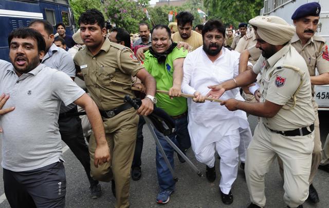 Pardeep Chhabra (in white) being escorted by the police in Chandigarh on Tuesday.