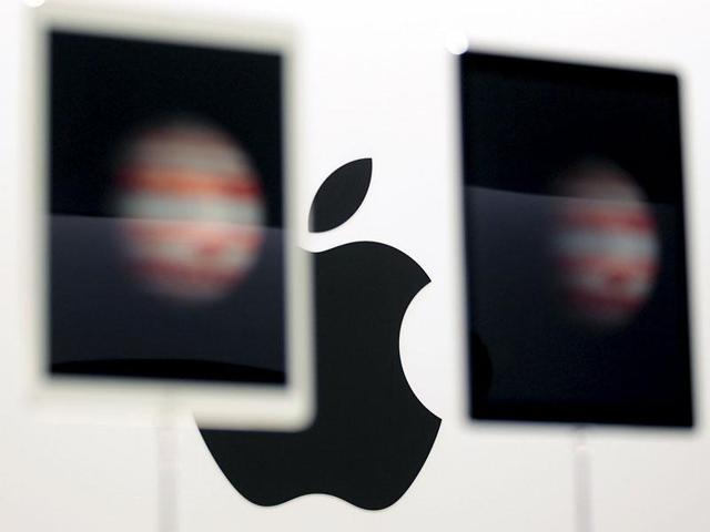 The Apple logo is seen behind new Apple iPad Pros on display during an Apple media event in San Francisco. (Reuters file photo)
