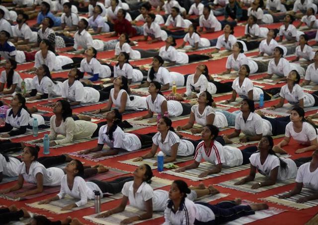 Mumbai university students perform yoga at Vidyanagari Sports Complex, Kalina .