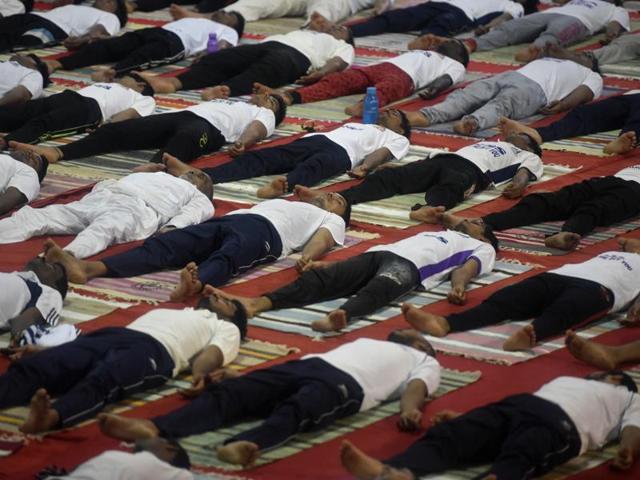 Mumbai university students perform yoga at Vidyanagari Sports Complex, Kalina . (arijit sen)
