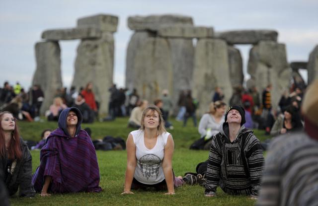 People perform yoga as they gather at the ancient stone circle Stonehenge, during the Summer Solstice, the longest day of the year, in Wiltshire. (AP) People perform yoga as they gather at the ancient stone circle Stonehenge, during the Summer Solstice, the longest day of the year, in Wiltshire. (AP)