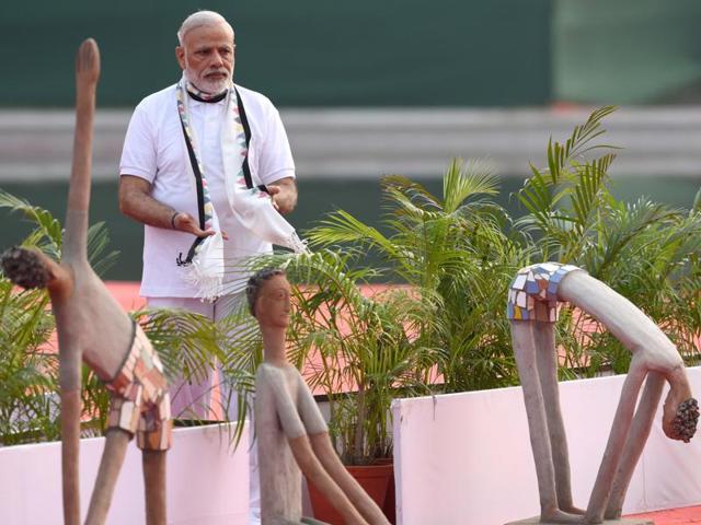 PM Narendra Modi behind sculptures showing asanas at the venue of the second International Day of Yoga, Capitol Complex, in Chandigarh, on Tuesday. (Sanjeev Sharma/HT Photo) 