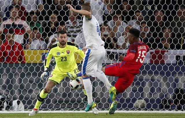 England's Daniel Sturridge (right) challenges Slovakia goalkeeper Matus Kozacik (left) during the Euro 2016 Group B football match between Slovakia and England at the Geoffroy Guichard stadium in Saint-Etienne, France. (AP Photo)