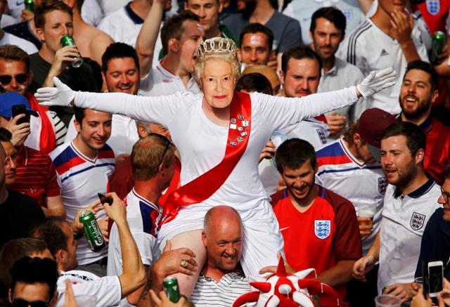 An England fan wears a mask of Queen Elizabeth II as he rides on the shoulders of his mates gathering in Saint Etienne ahead of their team's match against Slovakia. (Reuters Photo) An England fan wears a mask of Queen Elizabeth II as he rides on the shoulders of his mates gathering in Saint Etienne ahead of their team's match against Slovakia. (Reuters Photo)