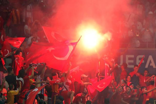 Turkey supporters wave the national flag and a flare during the Euro 2016 group D football match between Spain and Turkey at the Allianz Riviera stadium in Nice. (AFP Photo)