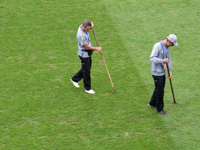 Two men work on the pitch prior to the Euro 2016 group A match between Switzerland and France at the Pierre-Mauroy stadium in Lille on June 19, 2016. The poor state of pitches of the Euro 2016 football tournament has triggered a debate among players and coaches.(AFP)