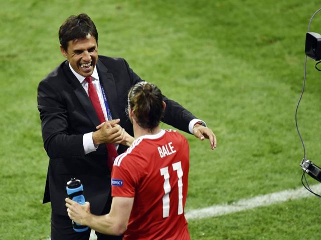 Wales' forward Gareth Bale is congratulated by coach Chris Coleman following the team's 3-0 win in the Euro 2016 group B football match between Russia and Wales. (AFP Photo)