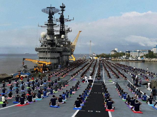 Officers and sailors of the Indian Navy participate in a yoga session on the deck of INS Viraat on the occasion of 2nd 'World Yoga Day' in Mumbai on Tuesday.(PTI)