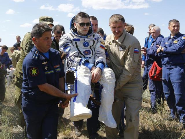 The International Space Station crew, from left, Britain's Tim Peake, Russia's Yuri Malenchenko and Tim Kopra of US, surrounded by ground personnel, rest shortly after landing near the town of Dzhezkazgan, Kazakhstan, on Saturday. (AP) The International Space Station crew, from left, Britain's Tim Peake, Russia's Yuri Malenchenko and Tim Kopra of US, surrounded by ground personnel, rest shortly after landing near the town of Dzhezkazgan, Kazakhstan, on Saturday. (AP)