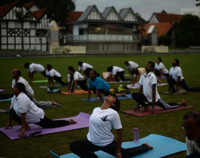 Malaysian yoga practitioners perform yoga exercises at the iconic Sultan Abdul Samad building in Kuala Lumpur. (AFP) Malaysian yoga practitioners perform yoga exercises at the iconic Sultan Abdul Samad building in Kuala Lumpur. (AFP)